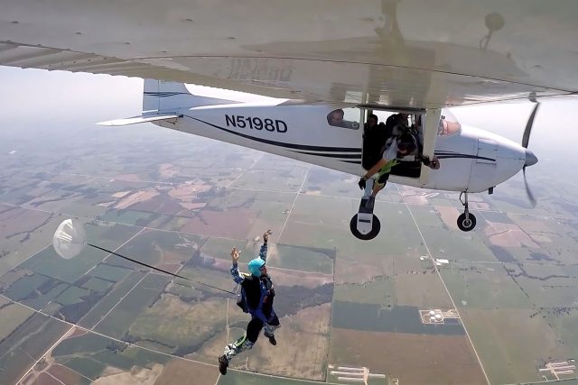 IAD student exits aircraft with arms raised