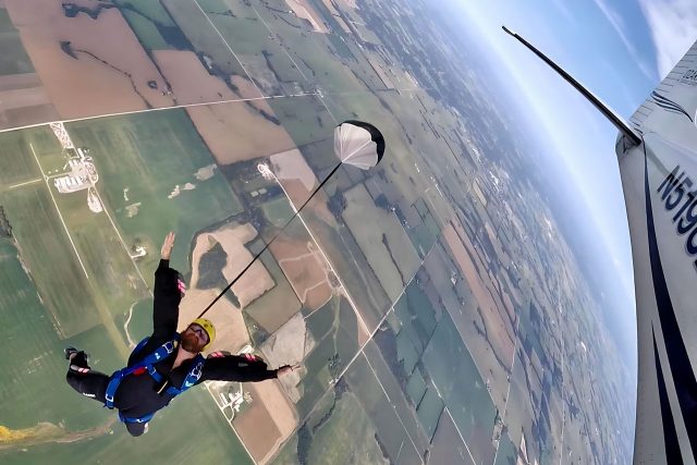 IAD student in freefall with arms raised