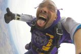 young african-american man smiles with mouth open in freefall